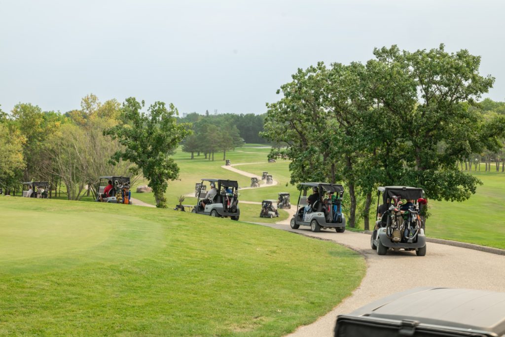golf carts drive through the course
